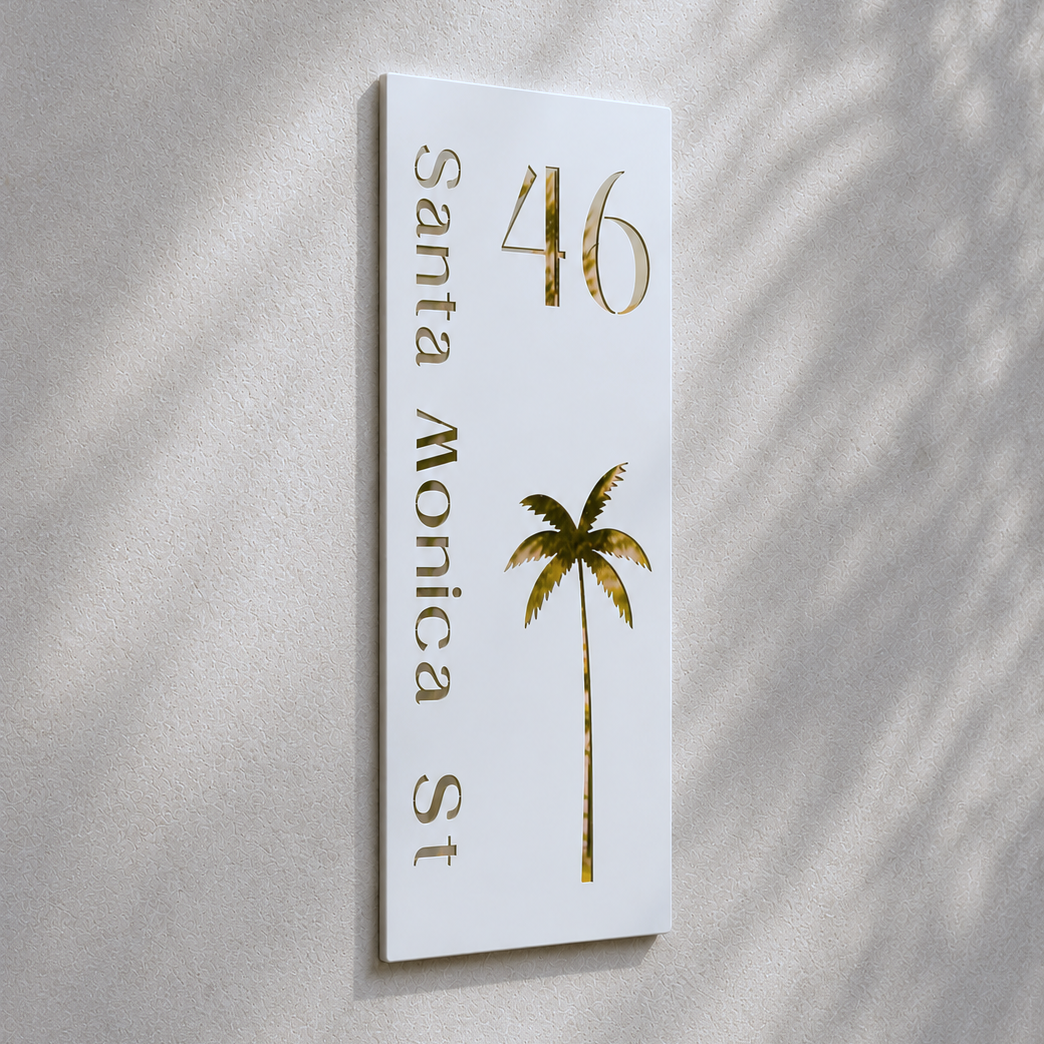 White sign with gold text and palm tree design on a textured wall