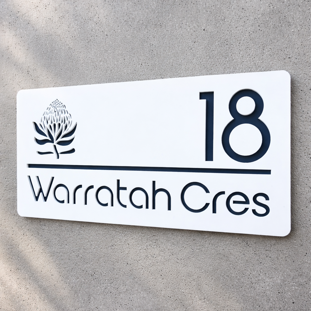 White house number sign with '18 Warratah Cres' on a concrete wall