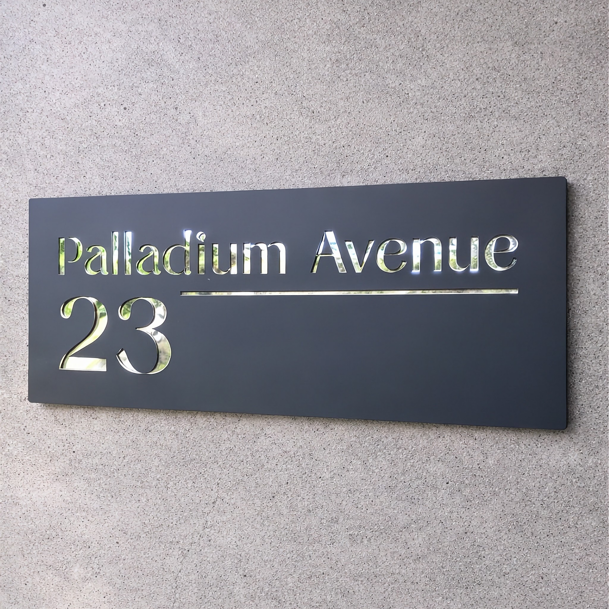 Address sign reading 'Palladium Avenue 23' on a gray wall.