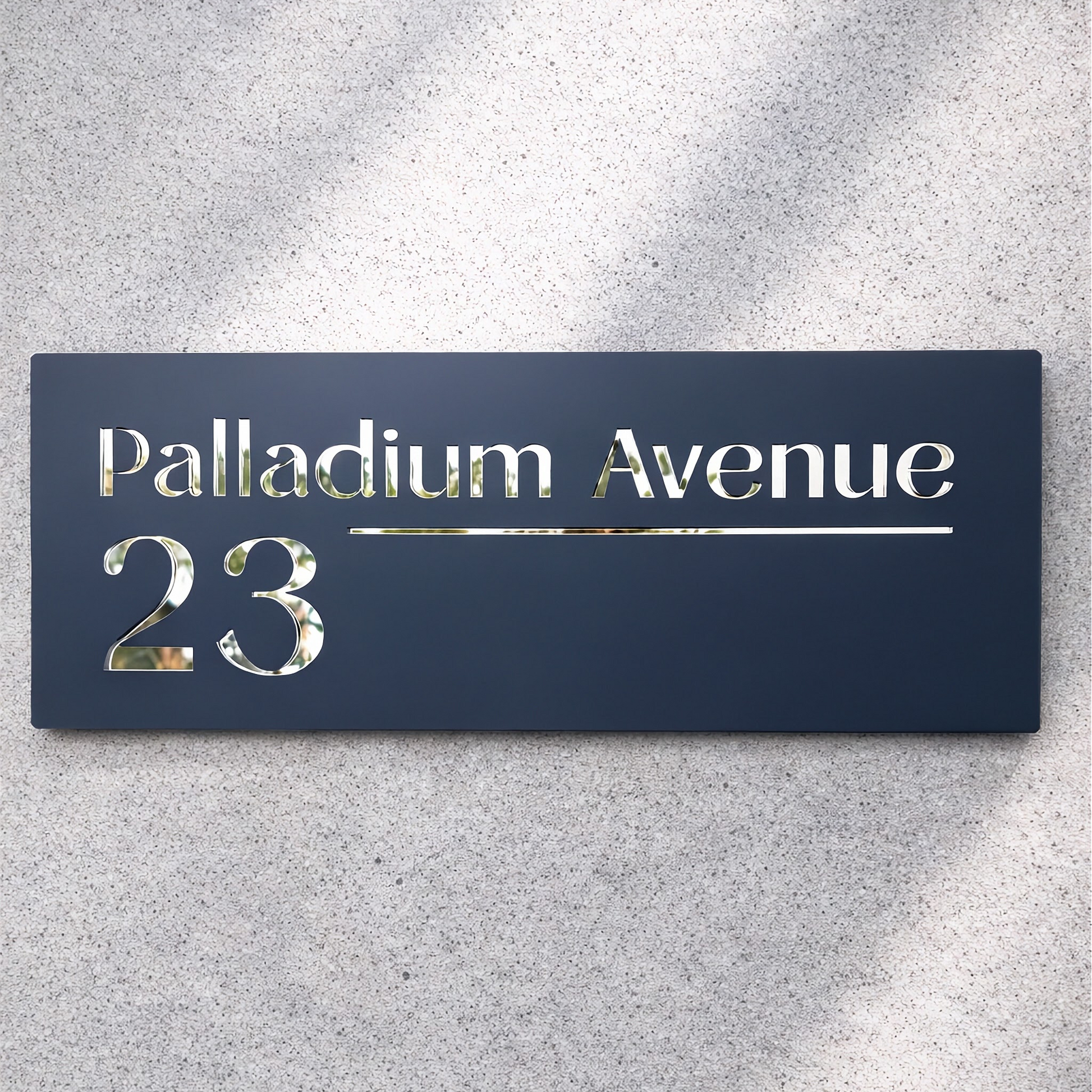 black sign with 'Palladium Avenue 23' on a gray background

