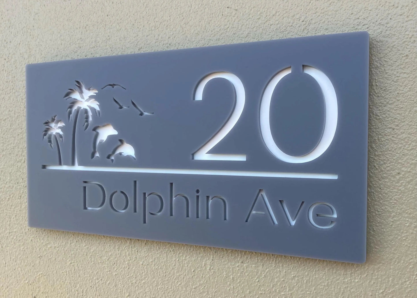 House number sign with '20' and 'Dolphin Ave' on a light gray background