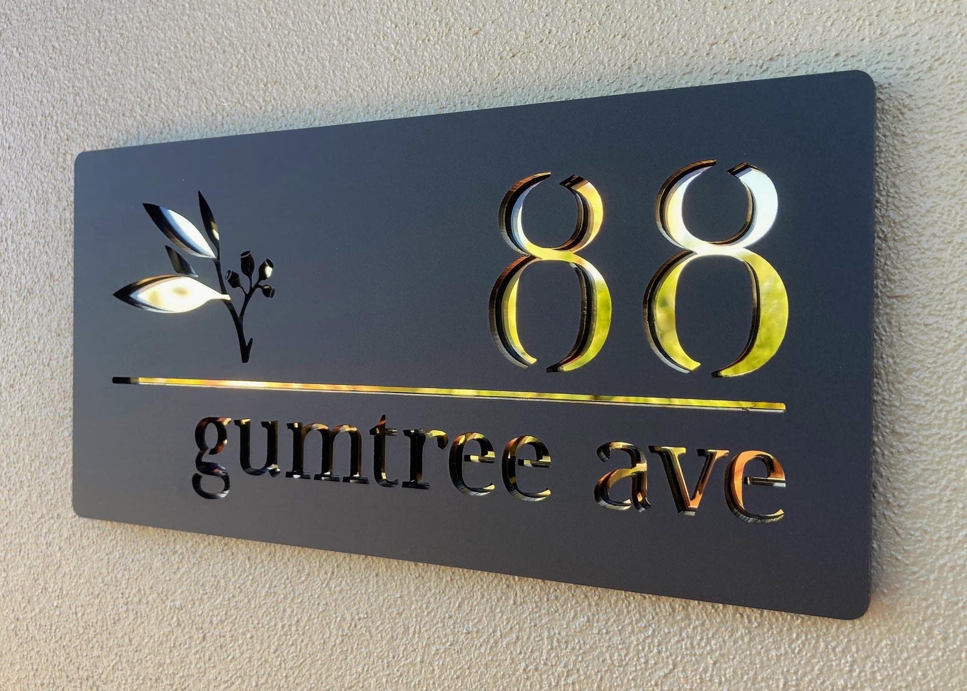House number sign with '88 gumtree ave' on a black background